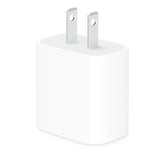 White power adapter on a white background. Front angled view of the compact Apple 40W dual USB-C port power adapter, featuring a sleek glossy white unibody design on a clean white background.